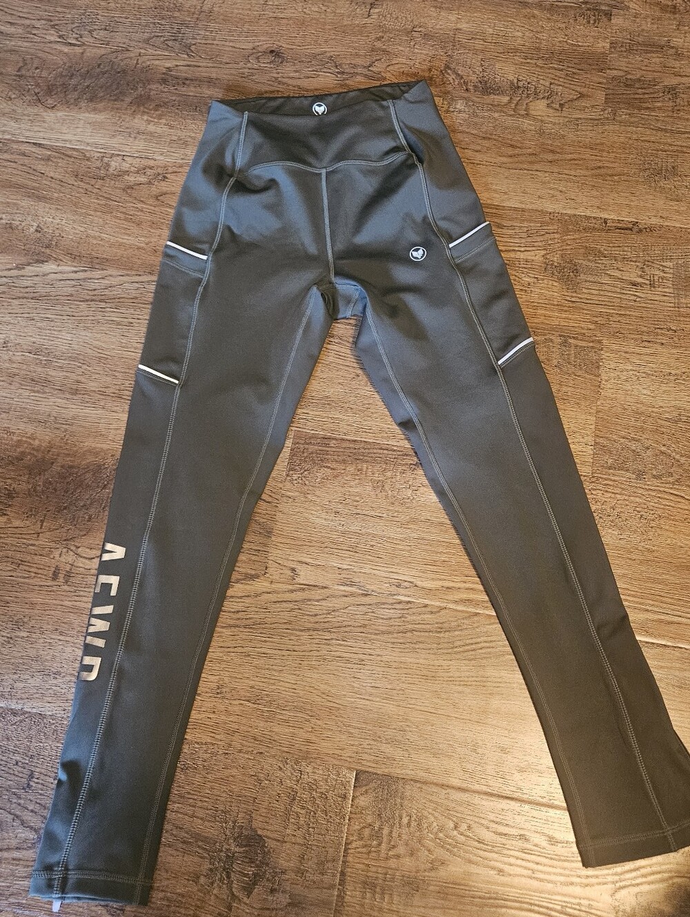 Alpha Forward AFWD Dark Green Performance Leggings with Reflective Accents.